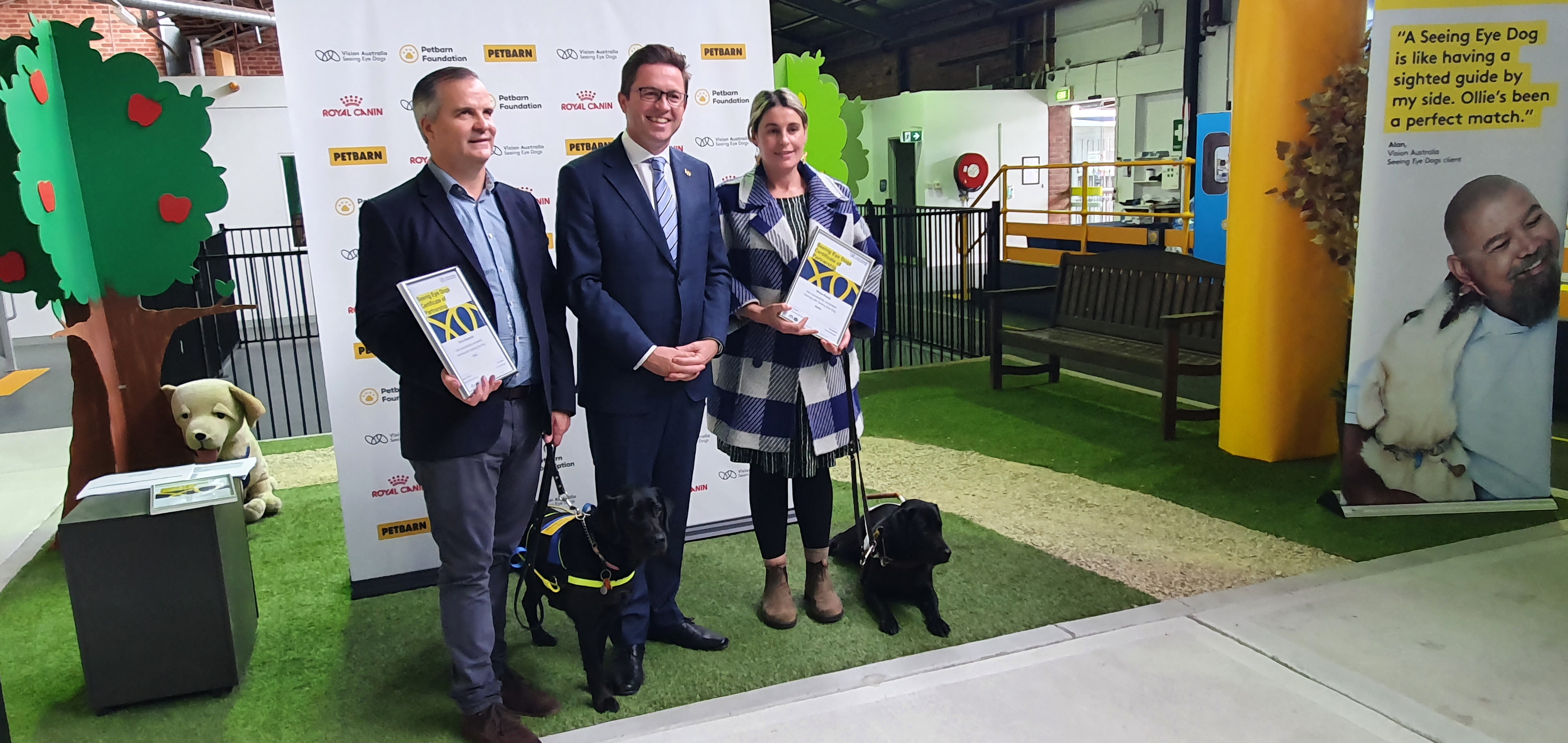 "Minister Anthony Carbines MP standng with graduates Chris Edwards with SED Eva and Olivia Penna with SED Astra"