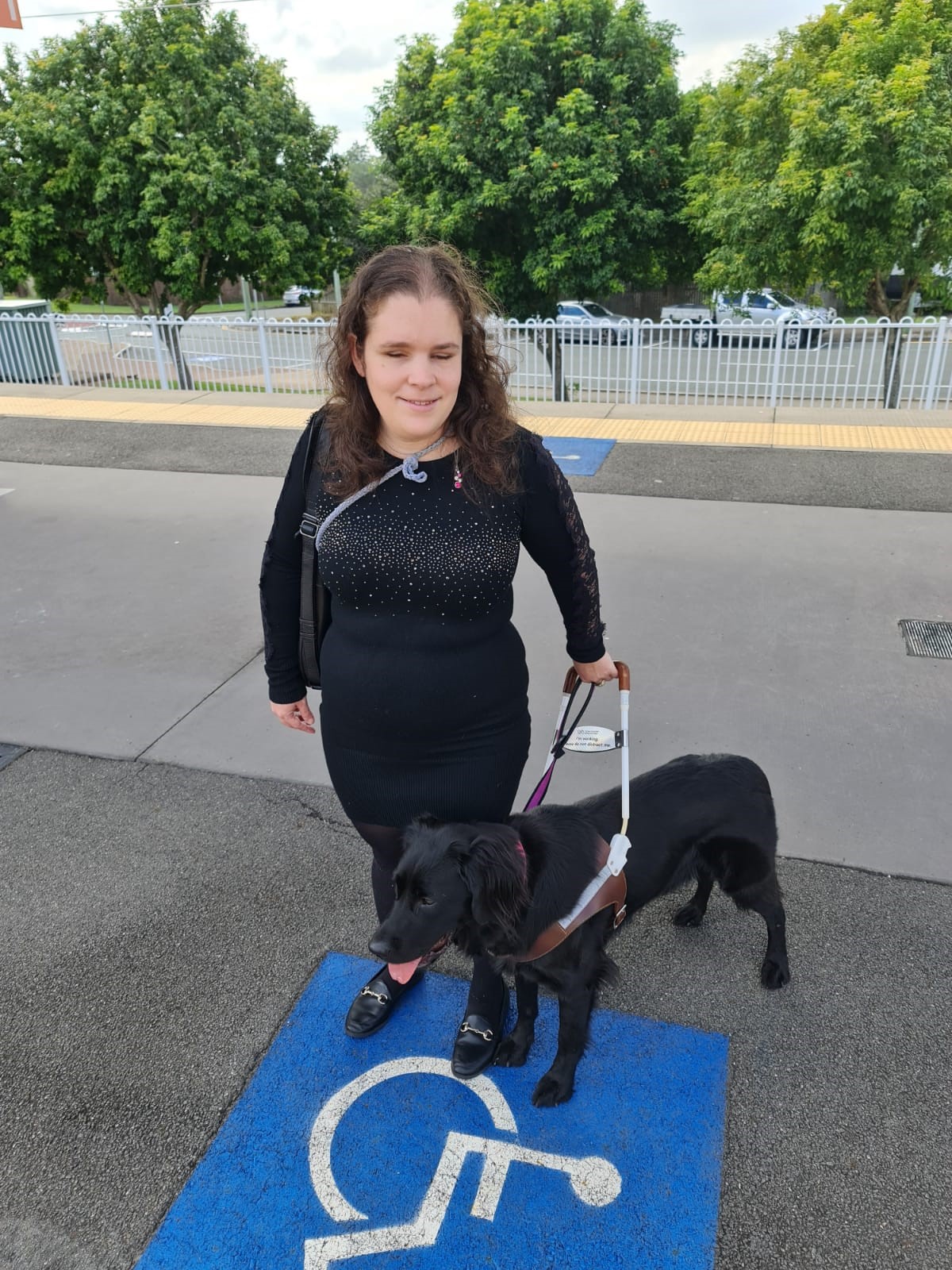 "Hailey and Tippi standing together at a train statiion."