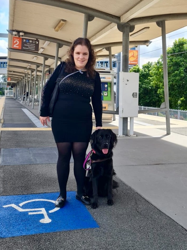 "Hailey and Tippi standing side by side at a train station"