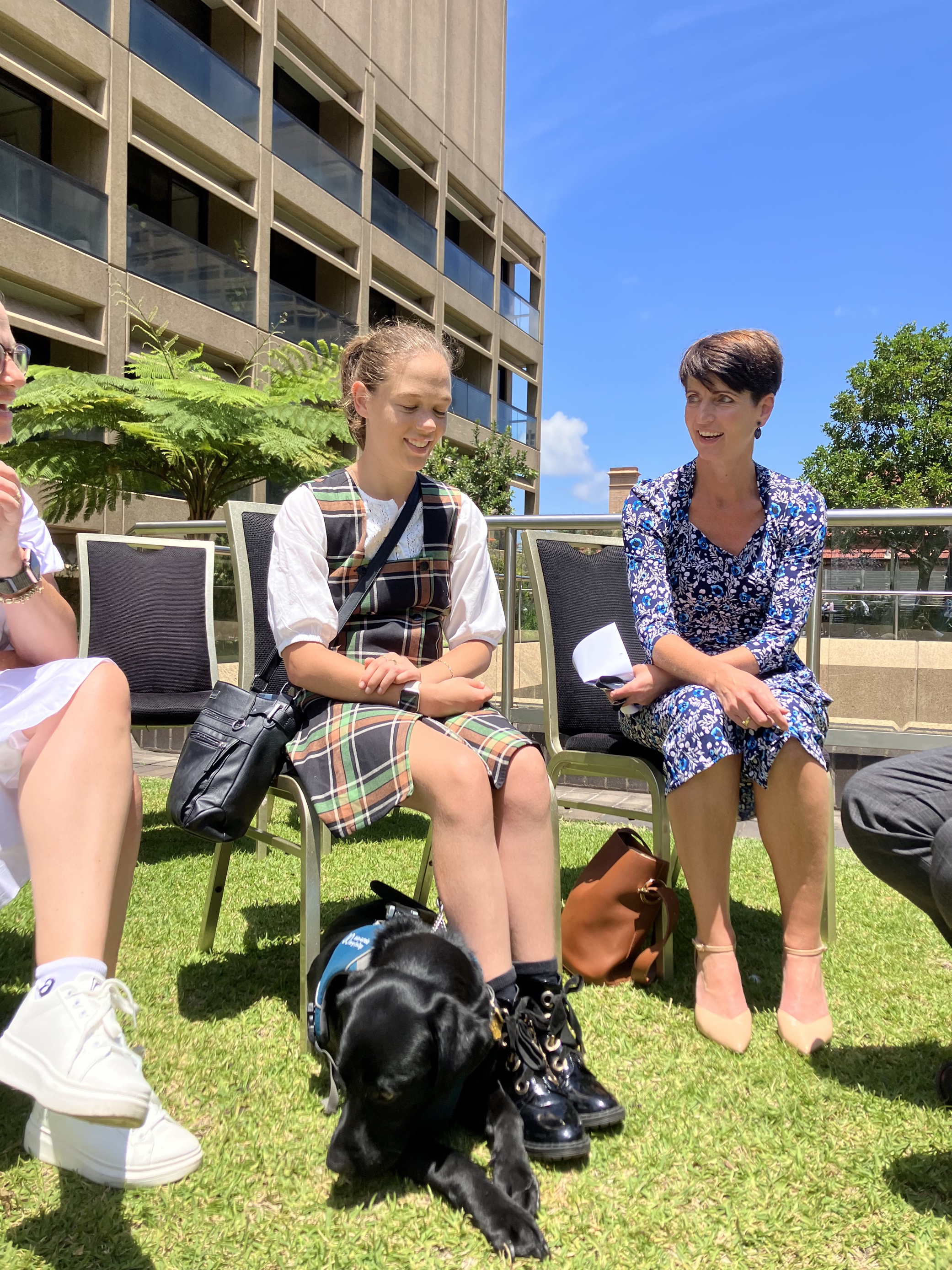 "Summer Giddings and her Seeing Eye Dog Lassie sitting next to Kate Washington, NSW Minister for Disability Inclusion at Parliament House"