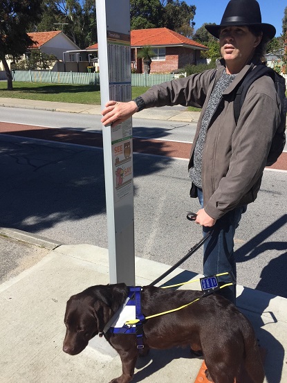 Image shows Tony and Papio at a bus stop