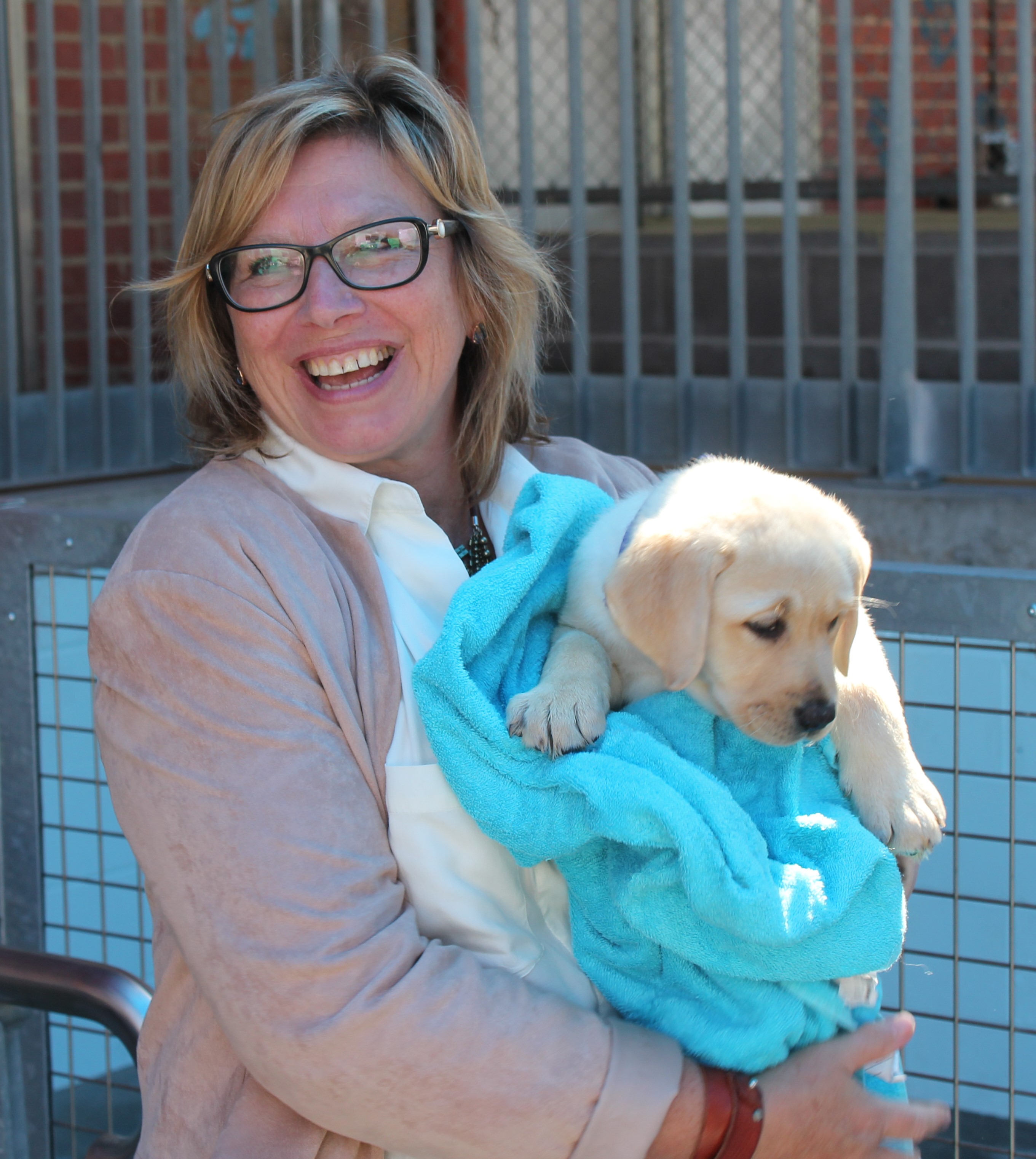 Rosie Batty smiling holding white Seeing Eye Dog Doris