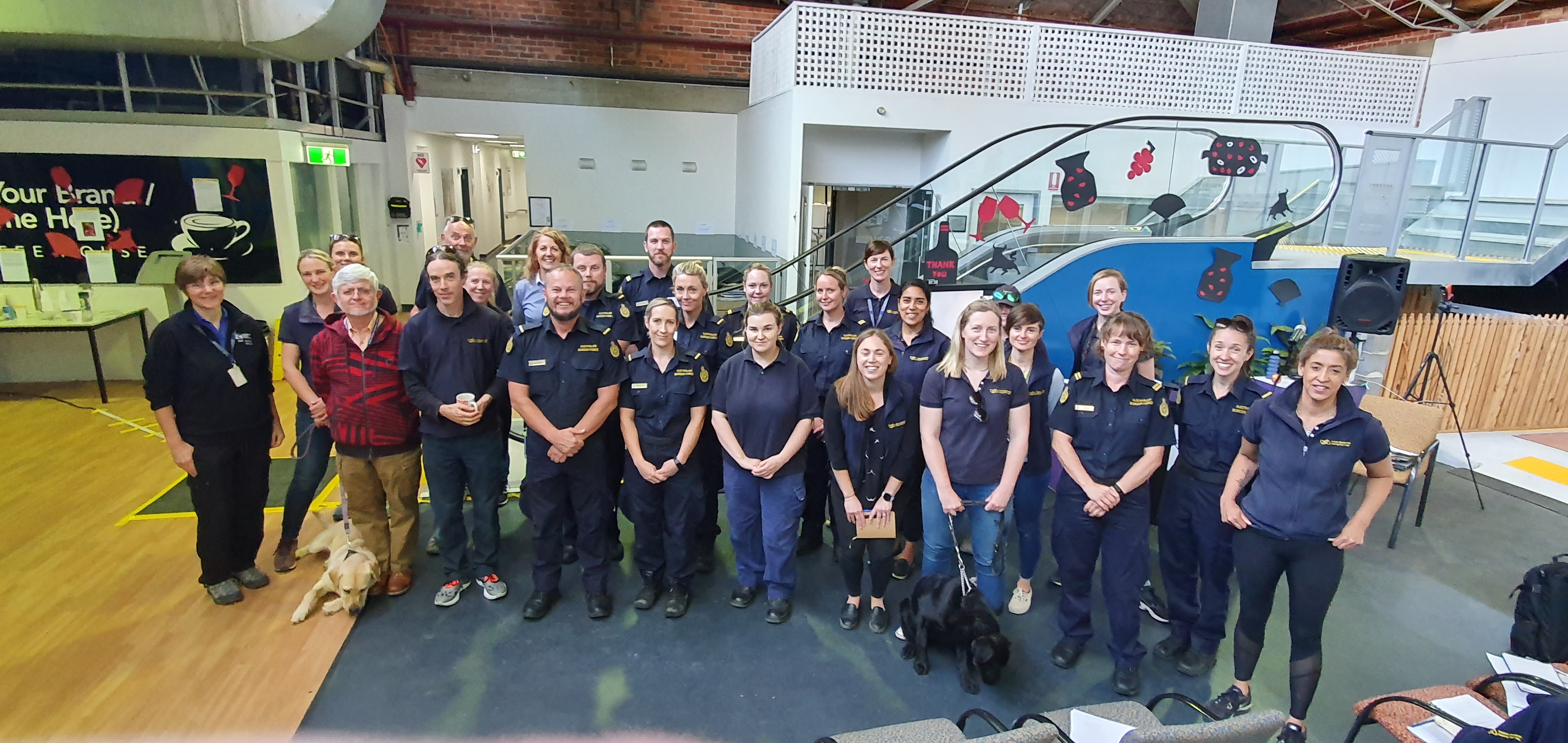 Jane Russenberger, Eldin Leighton, Border Force and Seeing eye Dogs staff stand for a group photo at the Mobility Training Centre