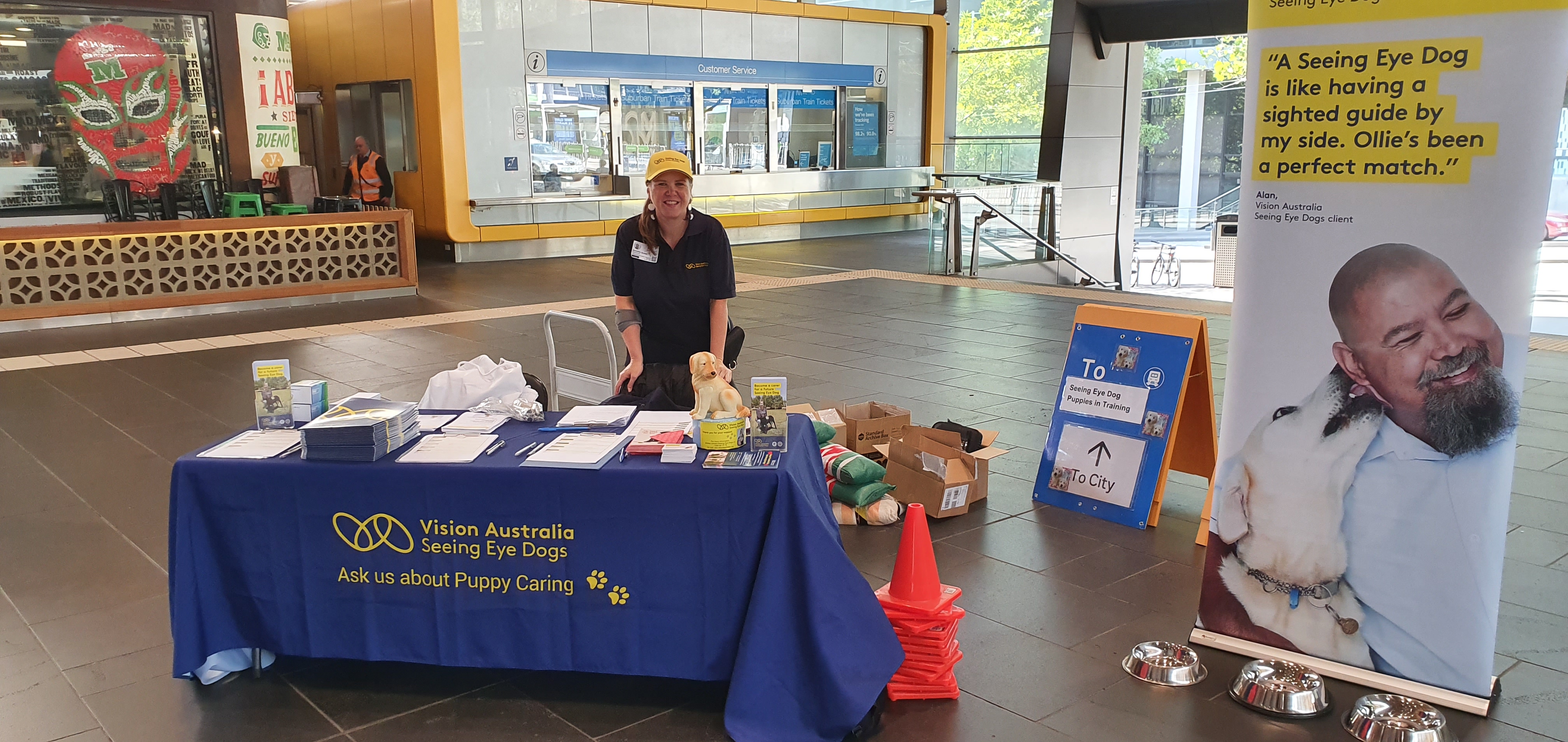 SED Team Member Danielle stands at our display table with information about puppy caring