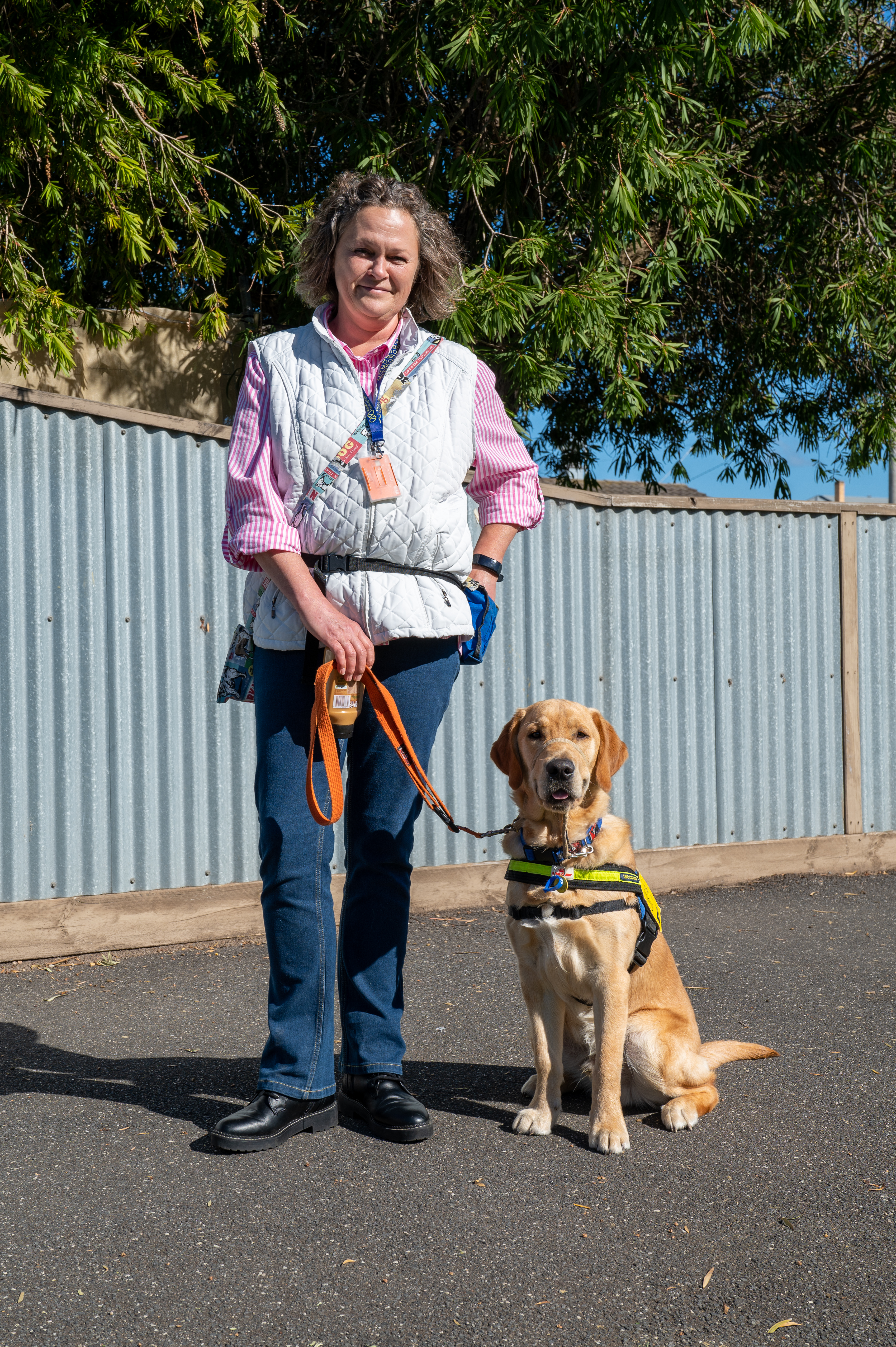 Patricia and Barkindji in front of a suburban house