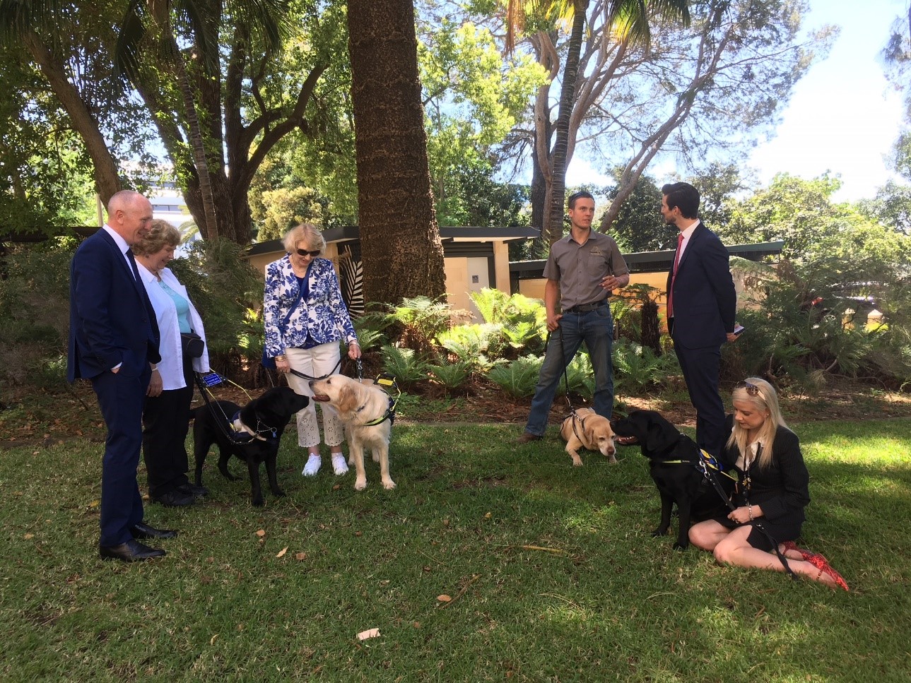 Group of clients with Seeing Eye Dogs and and Minister Dawson